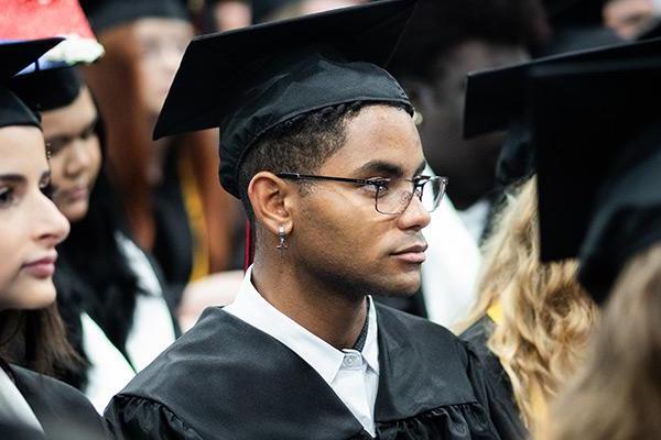 Student wearing cap and gown at graduation 